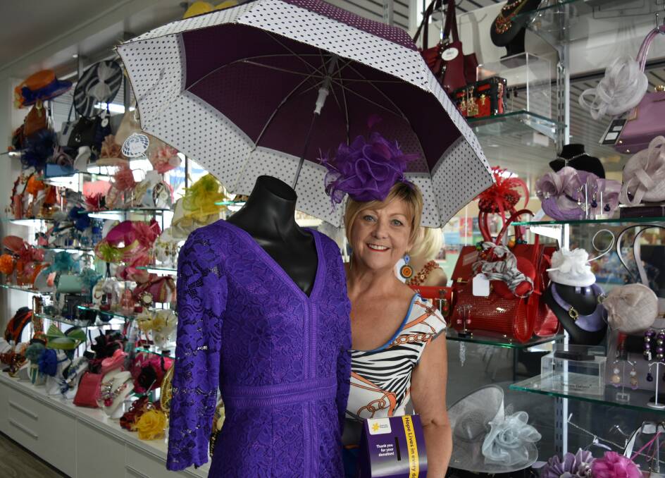INDIGO DELIGHT: Louise Kirby, owner of Louky Boutique, with a mannequin dressed in a purple dress. Photo: Hannah Baker