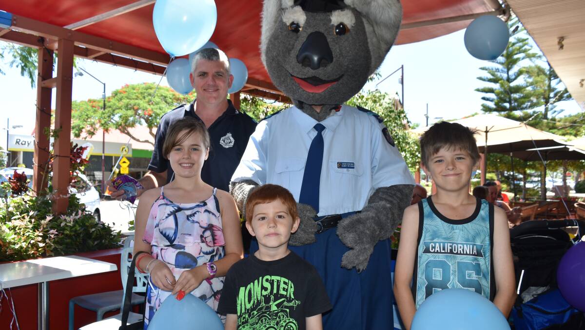 MASCOT: Siblings Faith, 11, Ashton, 7, and Zander Baldock, 9, stand with Queensland Police mascot Clancy the Koala and Senior Constable Gavin Anthony.