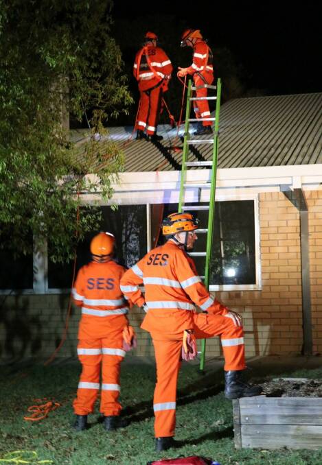 STORM RESPONSE: SES tend to a roof damaged in previous storm activity. Photo: File
