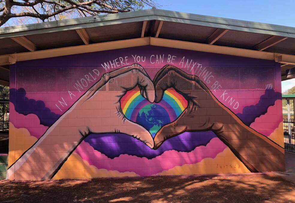 Two hands form a love heart, painted by Nitsua, underneath the text: "In a world where you can be anything, be kind." Photo: Supplied