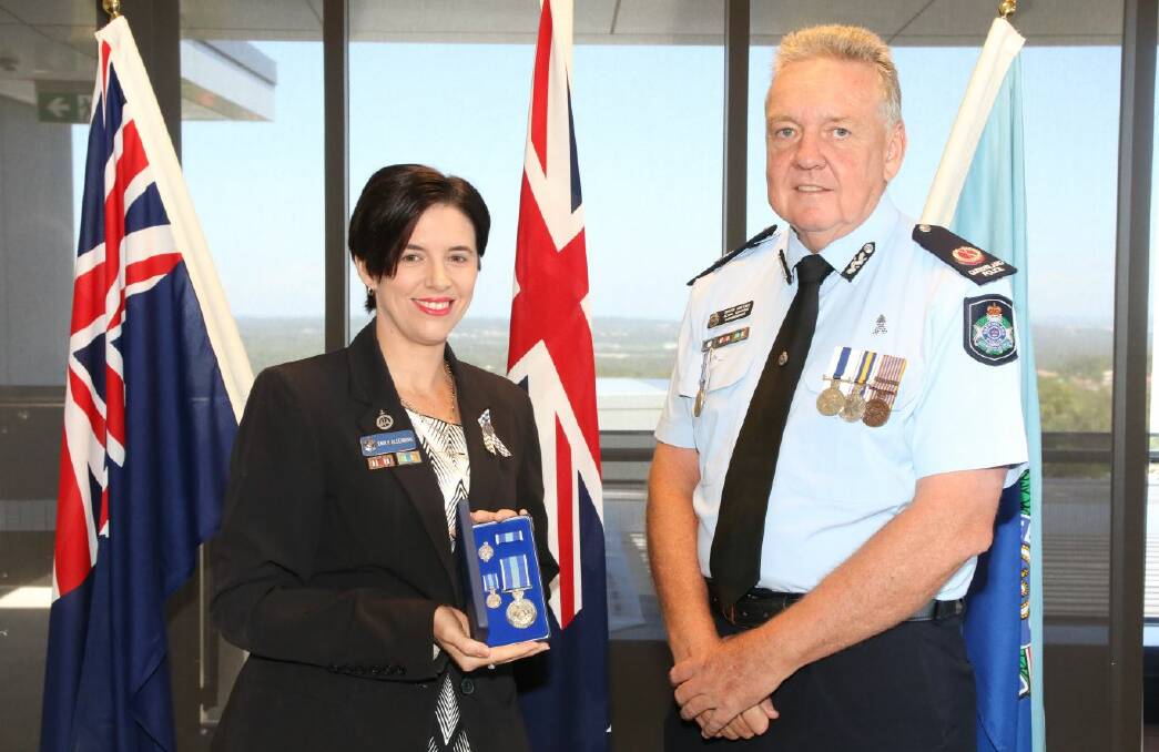 Cleveland prosecutor Emily Ollenburg was bestowed a Queensland Police Service Medal for ten years of fulltime service by Acting Assistant Commissioner Brian Wilkins. Photo: Queensland Police Service 