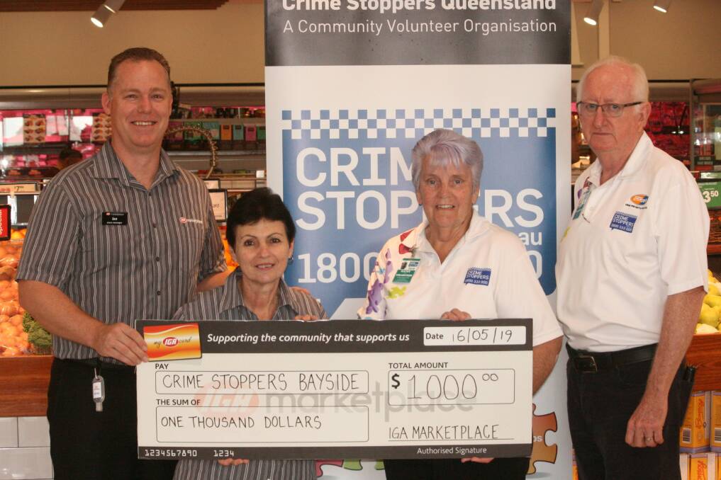 HANDOVER: IGA Marketplace Cleveland store manager Ian Day and customer service manager Angela Petralia, with Crime Stoppers Bayside volunteers Kathy Huf and Paul Fitzpatrick.
