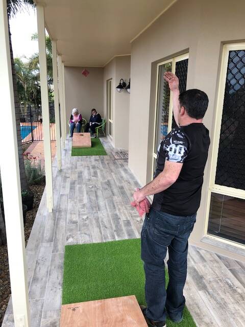 FUN TIMES: Sacks are thrown at slanted boards in the game Cornhole. Photo: Supplied