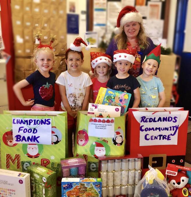 TINY HELPERS: Teacher Sheena Hewlett is helping kindy kids to collect gifts for Redland Community Centre. Photo: Supplied
