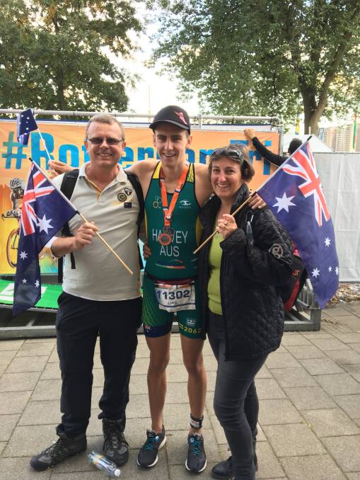CHAMPION: Luke Harvey with his parents Trevor and Megan after his first place win at the ITU World Triathlon Grand Finals, held in the Netherlands last year. Photo: Supplied