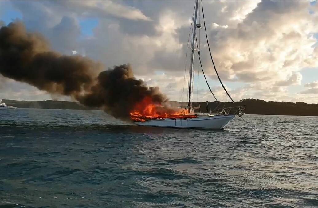 BLAZE: The boat, in waters south-west of Moreton Island, was engulfed by the time water police arrived. Photo: Queensland Police Service