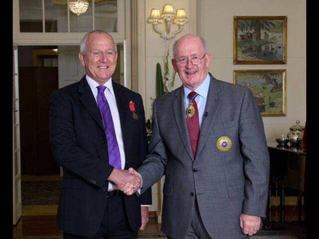 Macleay Island pilot Kevin Hughes was bestowed a bravery medal for his efforts to save a parachutist. He is pictured at the Canberra ceremony with Governor-General Peter Cosgrove. Photo: Supplied