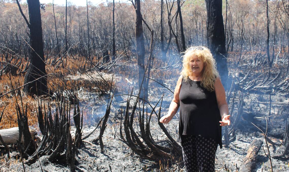WILDLIFE WARRIOR: Injured bird carer and Russell Island resident Sharon Keegan pictured the island's bushfires in February this year. Photo: Cheryl Goodenough