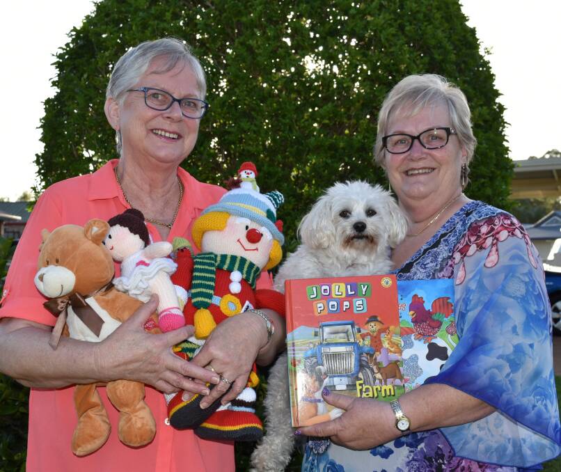 COMMUNITY SPIRIT: Capalaba sisters Jo Verhoeve and Adriana Kuhn with dog Fuzzy and some of the goods they have either made or collected. Photo: Hannah Baker