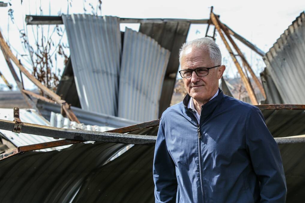 DEVASTATED: Prime Minister Malcolm Turnbull inspects the ruins of a house in the St Patrick's Day bushfires near Elingamite. Picture: Christine Ansorge
