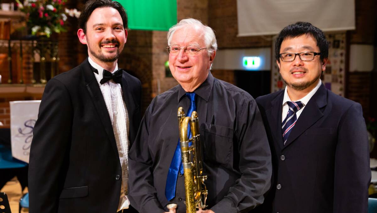CONDUCTORS: Wellington Point trumpet player Phil Davis (centre) joins Jacob Cavanough and Desmond Ng in conducting at a charity concert on June 7.