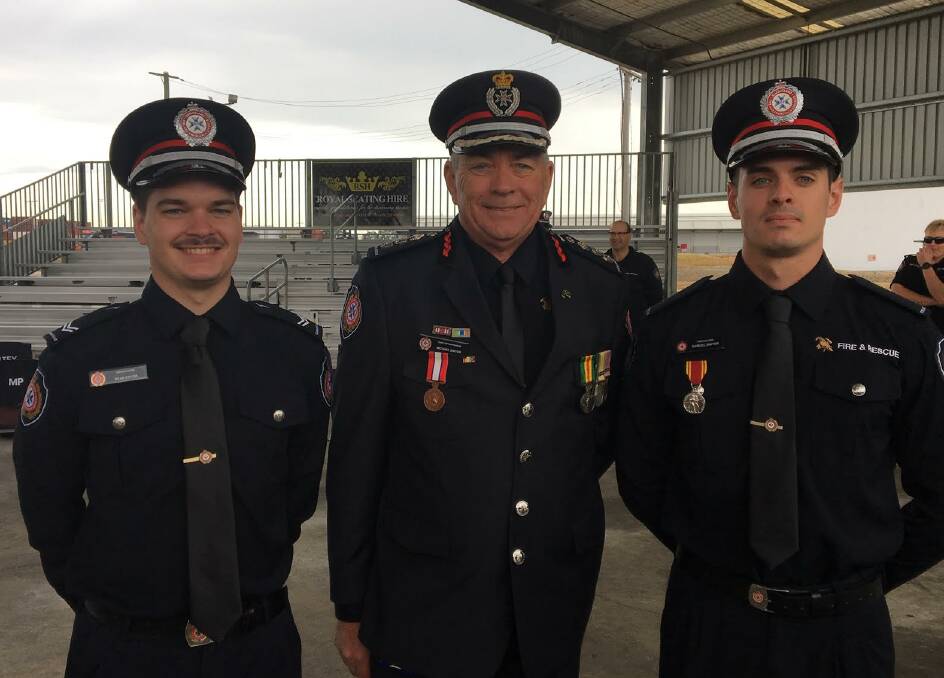 IN THE FAMILY: Chief Superintendant for Brisbane Michael Dwyer flanked by sons Ryan and Samuel, proudly carrying the family tradition and suggesting that people make careful personal fire prevention plans.