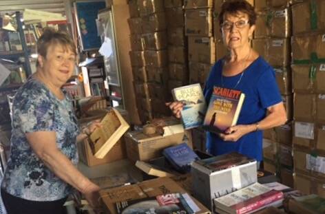 BOOK FEST: Capalaba Rotarians, Beverley Allsop and Jan Lasson, sort books in preparation for BookFest from October 26 to 28.