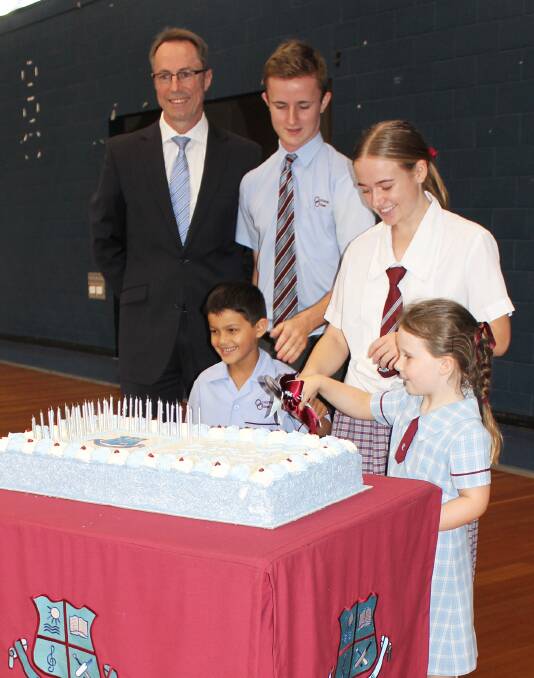 BIRTHDAY: Ormiston College Headmaster, Brett Webster and College captains Sam Meaney and Brittany Bell cut the Ormiston College 30th anniversary celebration cake along with Prep students, Oliver Jones and Olivia Baxter.