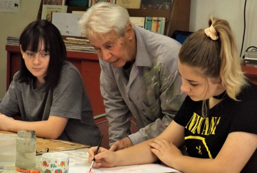 TUTOR: Emerging Redland artists Dani Jayde Lewis and Baylee Rose Chilman work with professional tutor Robin Wilson at a Yurara Art Society mentorship session. Both students intend to enter the 2019 Redland Youth Art Awards.