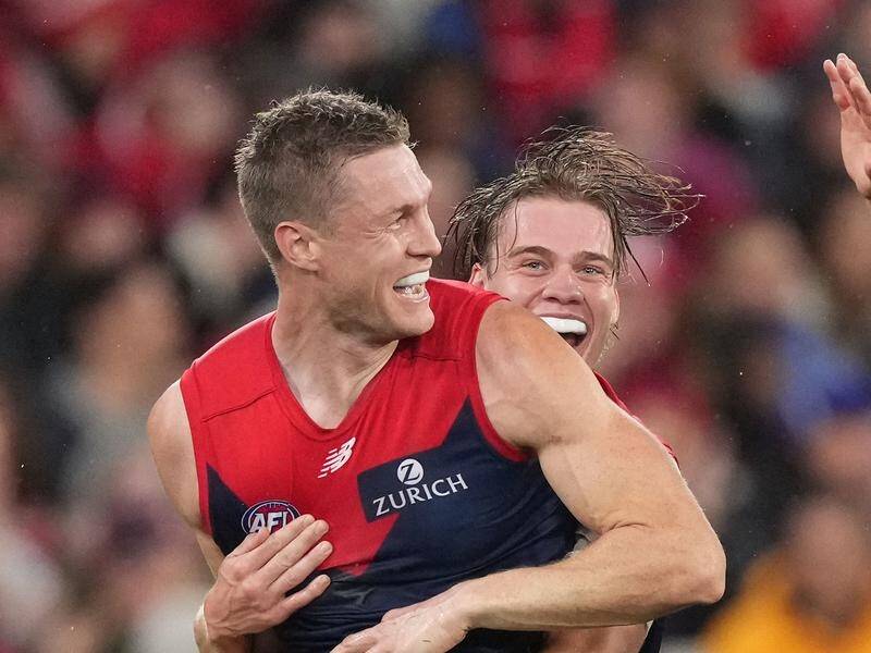 Demons' in-form Tom McDonald being congratulated by teammates after a goal against the Swans.