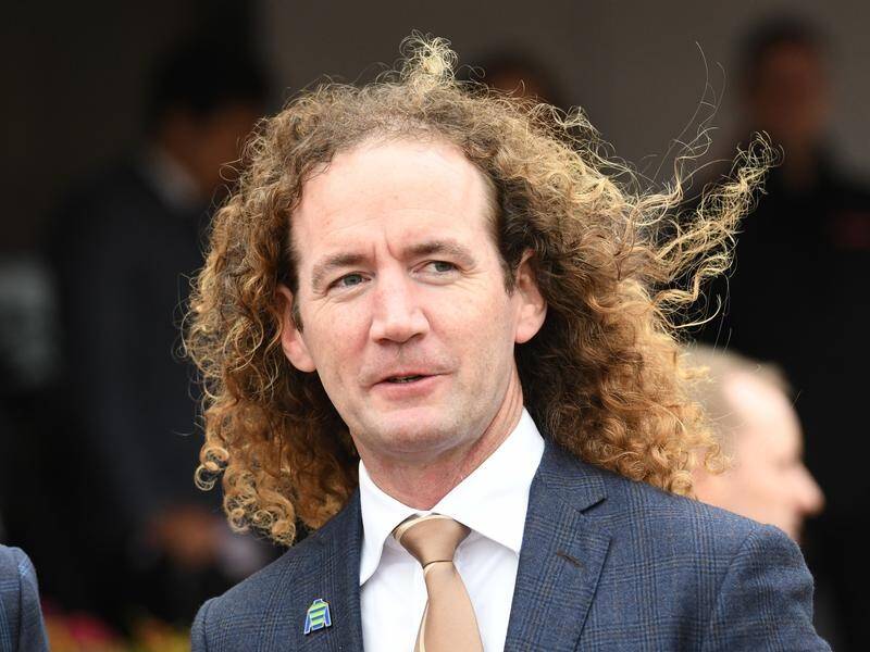 Trainer Ciaron Maher has been fined $300 for not wearing a safety vest aboard a horse at the beach.
