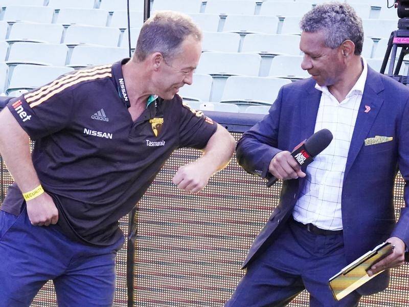 Hawks coach Alastair Clarkson greets Gilbert McAdam in virus-appropriate style at the MCG.