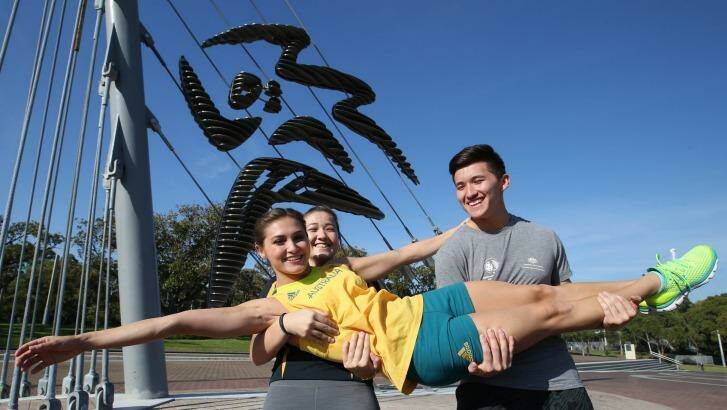 Heavy lifting: Melissa Wu is lifted by siblings Joshua and Madeline. Photo: Peter Rae