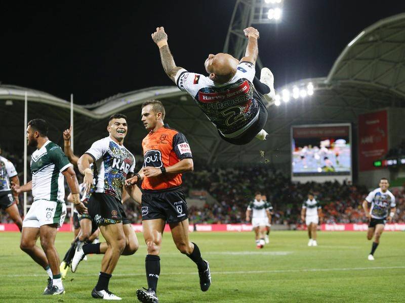 Blake Ferguson celebrates scoring a try for the Indigenous All Stars against the Maori All Stars.