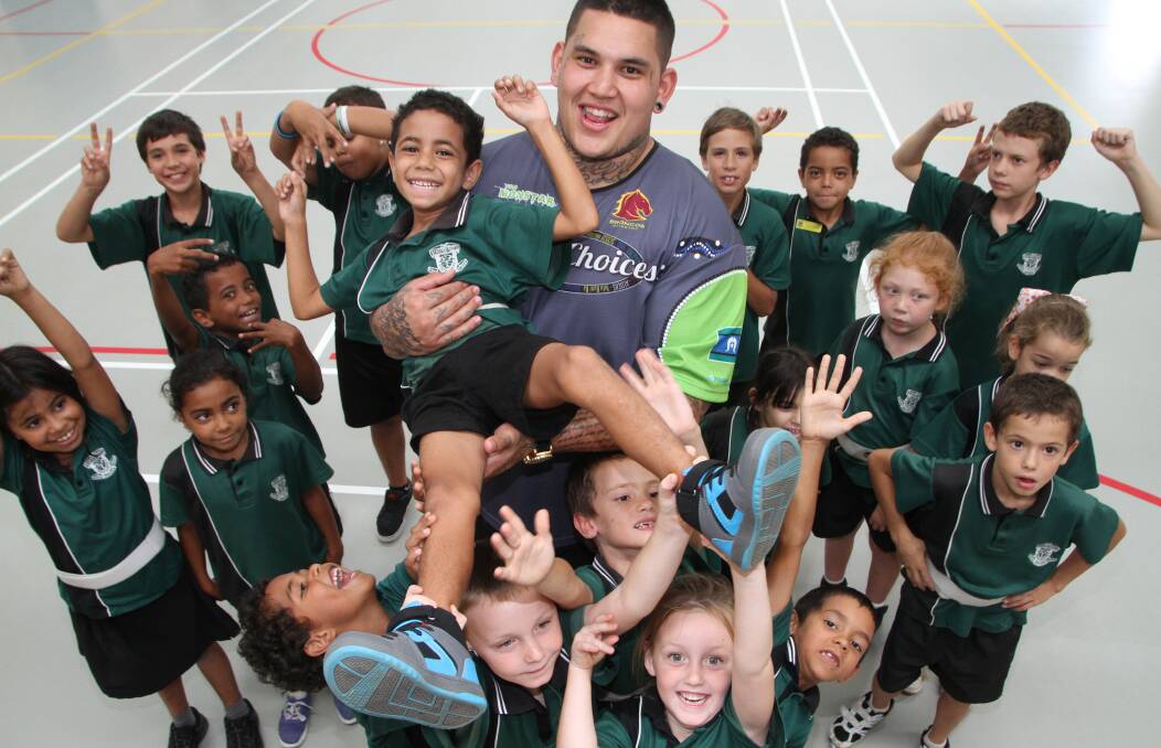 getting the MESSAGE: Tha Monstar Jesse Williams holds Vienna Woods State School year 2 student Desmond Watego aloft as other students hearing the Deadly Choices message look on. 
 Photo: Chris McCormack