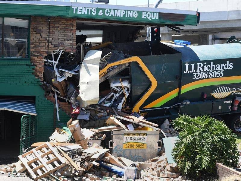 A garbage truck driver has died after his vehicle ploughed into a Brisbane camping shop.
