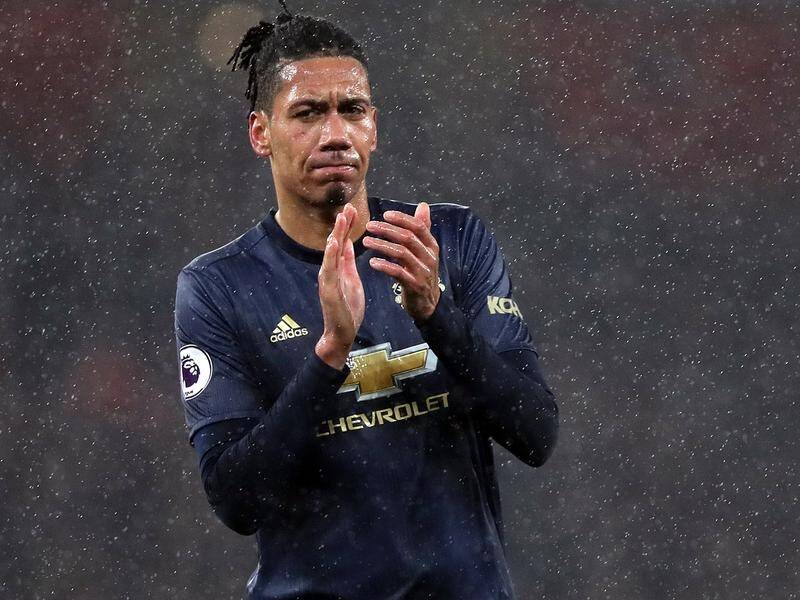Manchester United's Chris Smalling was allegedly pushed by a pitch invader at the Emirates Stadium.