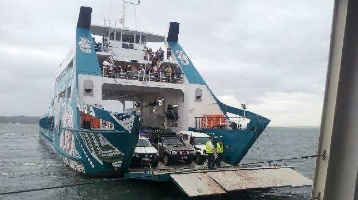 Stradbroke Ferries attempts to get passengers off its stranded Red Cat ferry. Photo: Luke Brown