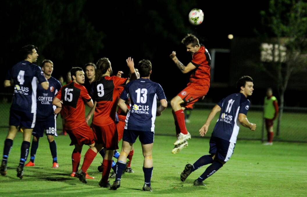 REACH FOR THE STARS: Lyndon Dykes climbs high against Olympic FC during his time at Redlands United. 