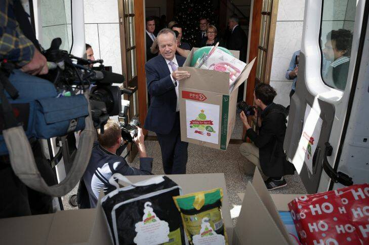 Opposition Leader Bill Shorten helps load the van with gifts from the Kmart wishing tree at the Prime Minister's office at Parliament House in Canberra.l Photo: Alex Ellinghausen
