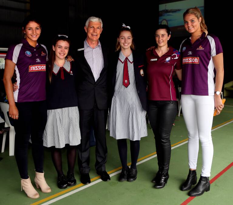 Queensland Firebirds Kim Ravaillion (left) and Gretel Tippett (right) with Carmel College students Jade Leibbrandt and Britaney Carmody, college principal Brian Eastaughffe (third from left) and competition convenor Jenna McKnight (second from right). Photo by Stephen Archer