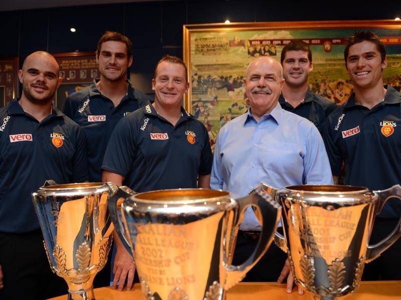 Leigh Matthews (third from right) and Simon Black (right) with the three premiership cups in 2012.