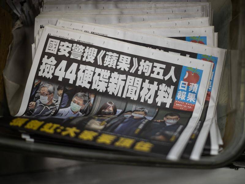 Supporters flocked to buy copies of Hong Kong's Apple Daily to protest a raid of its offices.