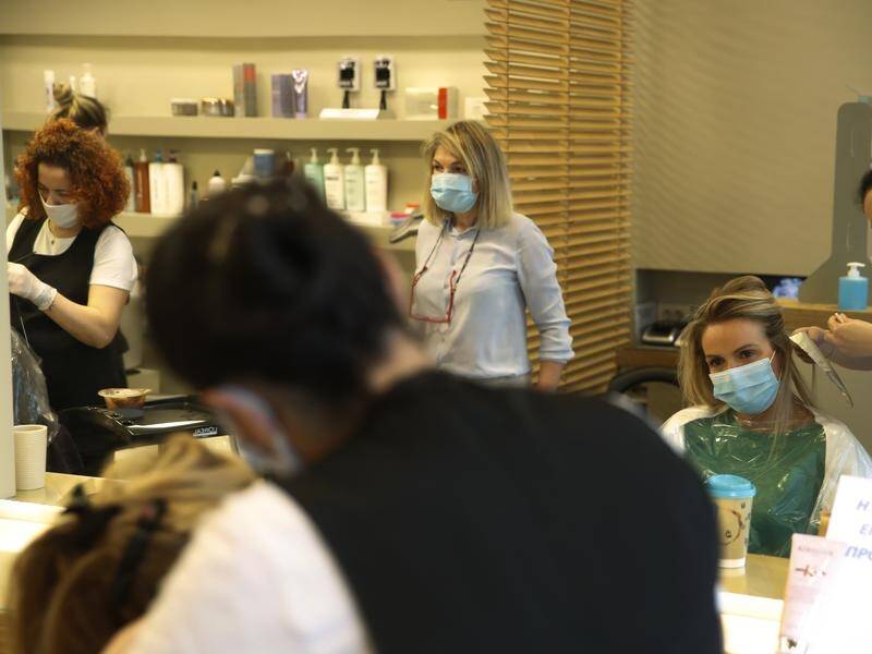 Customers are back in hair salons in Greece after some coronavirus restrictions were lifted.