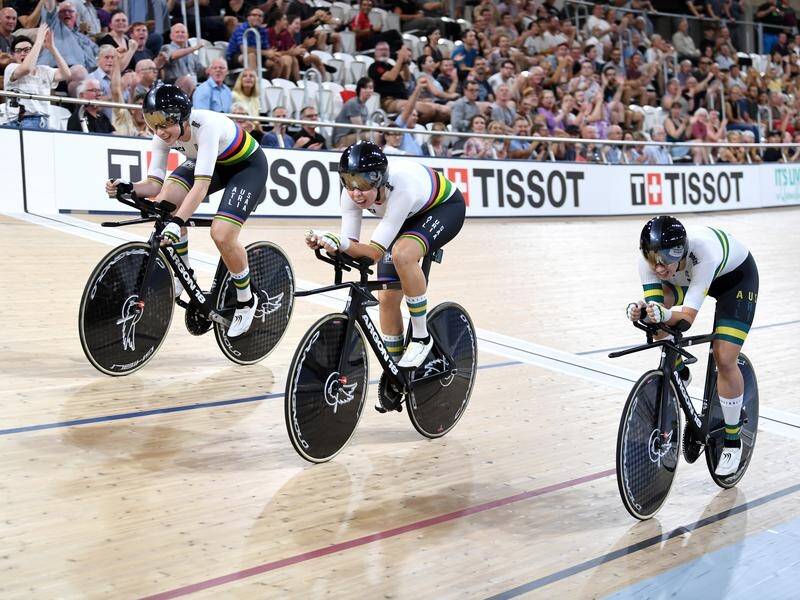 Australian women's team pursuit outfit members seen after crossing the finish line to win gold.