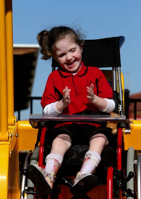 Isabella Wallace enjoys the first ride on the swing. Photo by Stephen Archer.