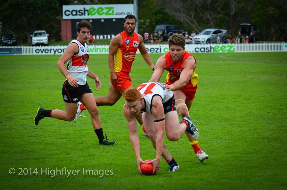 ON THE BALL: Blake Grewar and Damian Steven (Redland) with Jeremy Taylor and Karmichael Hunt (Gold Coast Suns). Photo: Highflyer Images