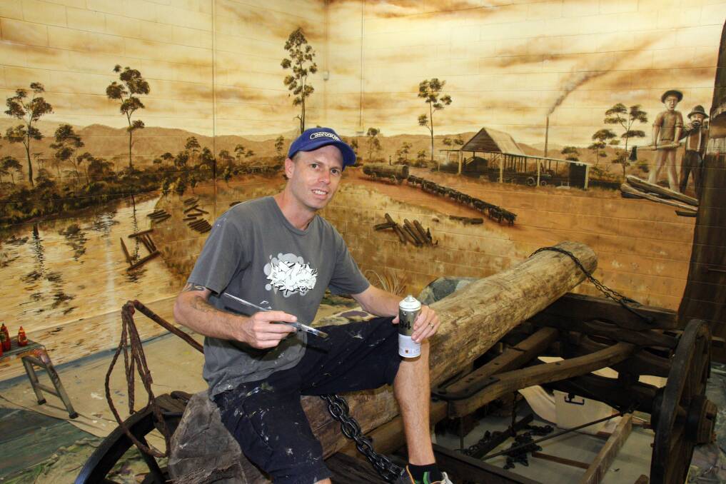 Artist Christian Griffiths puts the finishing touches to a new mural at Redland Museum. 
Photo by Chris McCormack