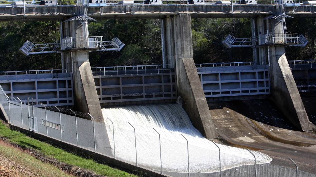 Water spills out of Leslie Harrison Dam as Seqwater gets its maintenance program under way. PHOTO: Stephen Archer