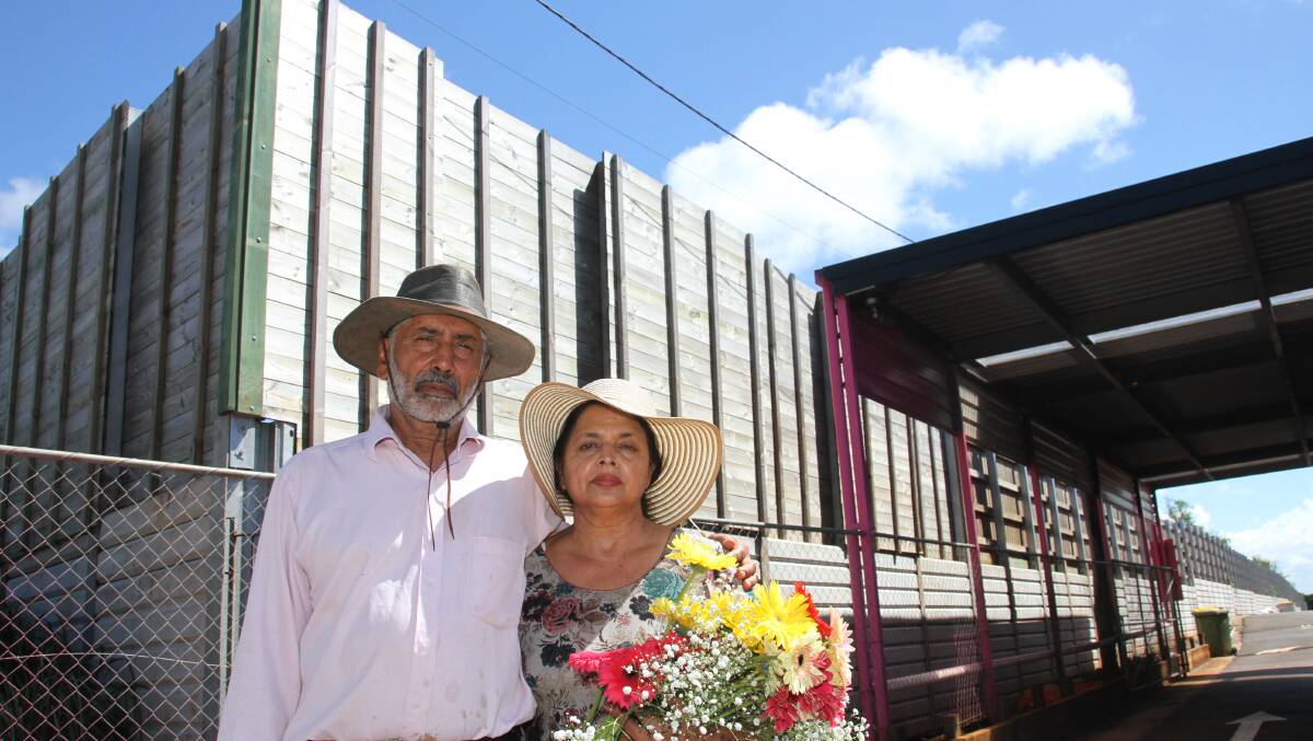 Birkdale Flower Farmers Tarsem Singh Sihota with wife Harbans in front of the retaining wall and fence. PHOTO: Chris McCormack
