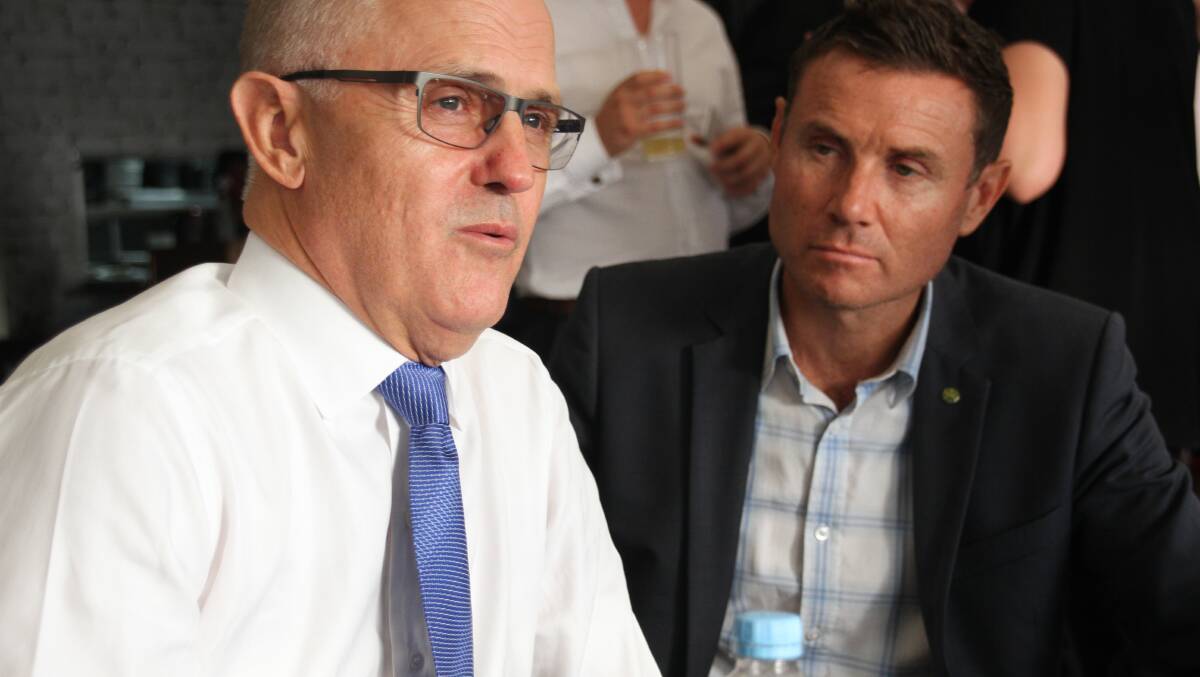 Communications Minister Malcolm Turnbull answers questions on the rollout of the NBN while Bowman MP Andrew Laming listens at Raby Bay Harbour. PHOTO: Chris McCormack