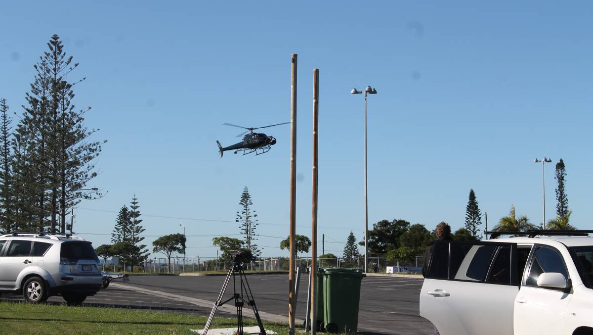 A chopper, with cameras strapped to the front, arrives at Raby Bay VMR after taking aerial shots of the Dying Gull, which was docked in Raby Bay Harbour on Monday. 