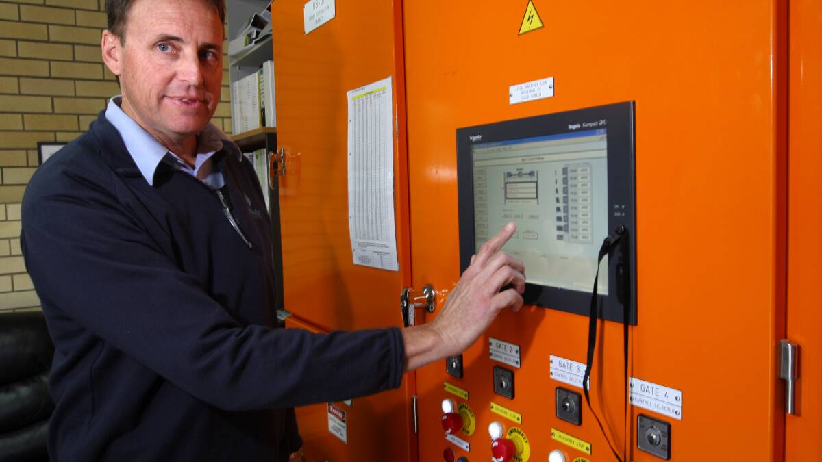Seqwater operations coordinator Craig Duncan presses the button to change the gate levels. PHOTO: Stephen Archer