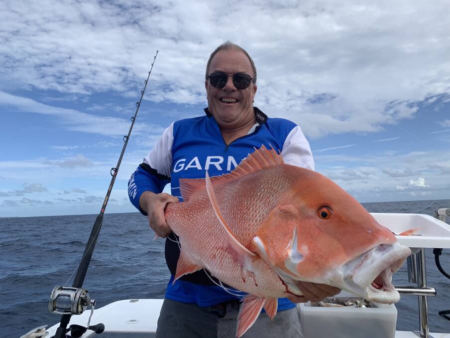 SOLID: Malcolm McDougall with a solid red emperor caught while holidaying off Gladstone.