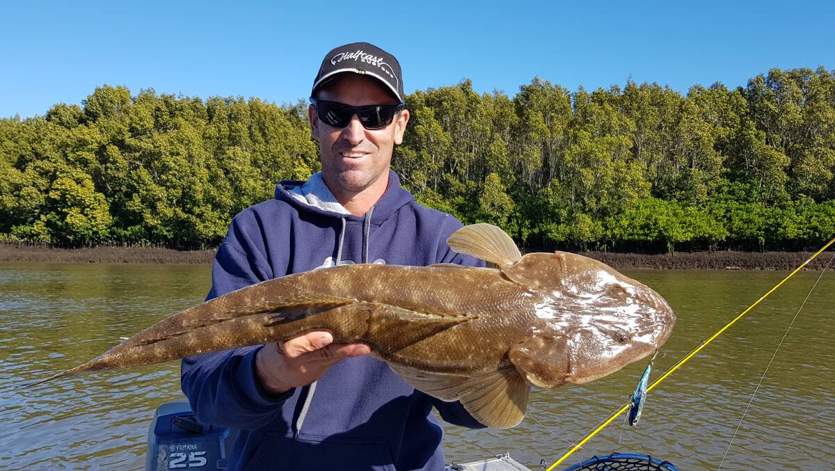 FISHING MACHINE: Fishing machine Randy Keeble with a great lure-caught flathead from the Brisbane River.