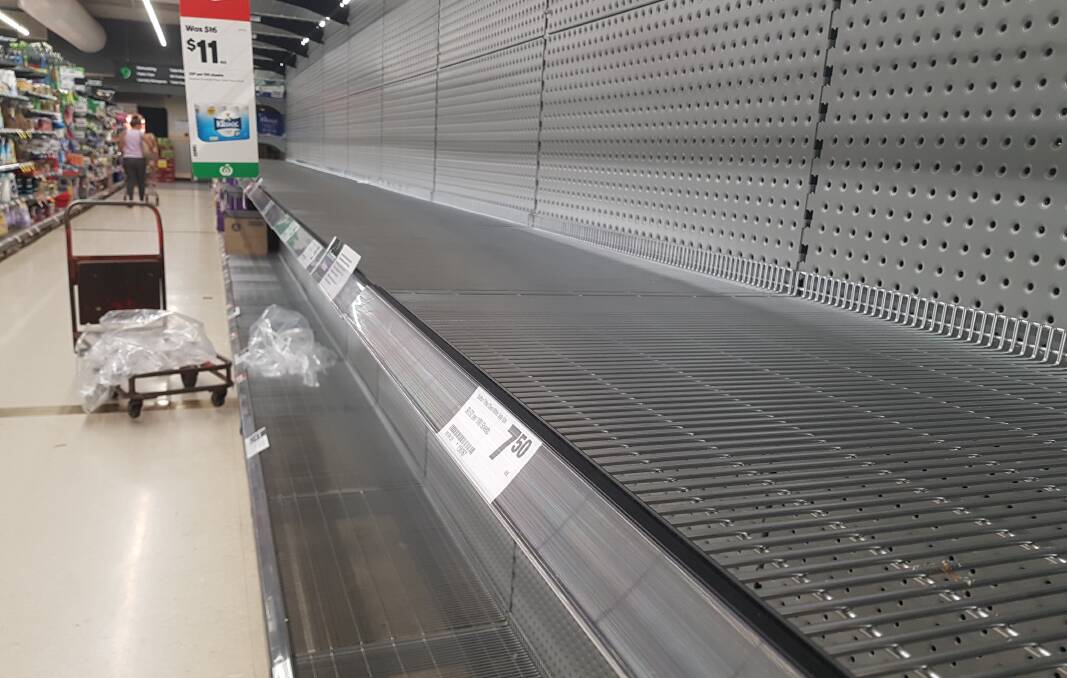 Bare: Jimboomba's Woolworths shelves were empty this week as shoppers rushed to pick up toilet paper.