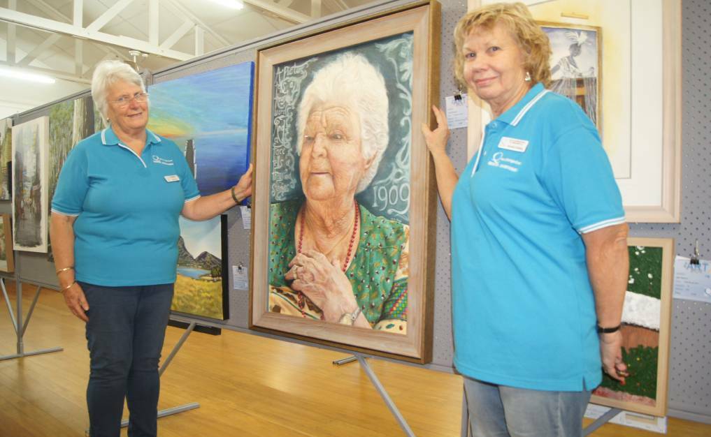 WORK OF ART: Jimboomba Quota International Club members Judy Porter and Brenda Fielding with a display from a past Quota International Art Show.