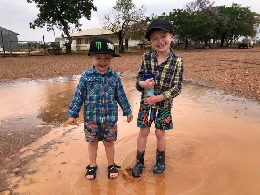RAINY WEEKEND: These youngsters enjoyed the weekend's rain near White Cliffs in parched New South Wales.