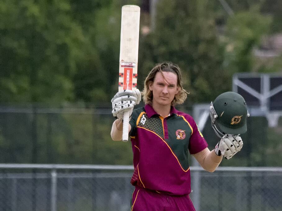 HERE'S A TON: Redlands 1st grade player Michael Herdman raises his bat after scoring a quick fire 117 runs off 58 balls in the one day game played at Redlands last Sunday.