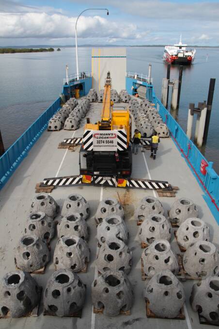 128 concrete reef balls stacked on the deck of a Stradbroke Ferries barge before it took them to Peel Island's artificial reef. Photo: Chris McCormack